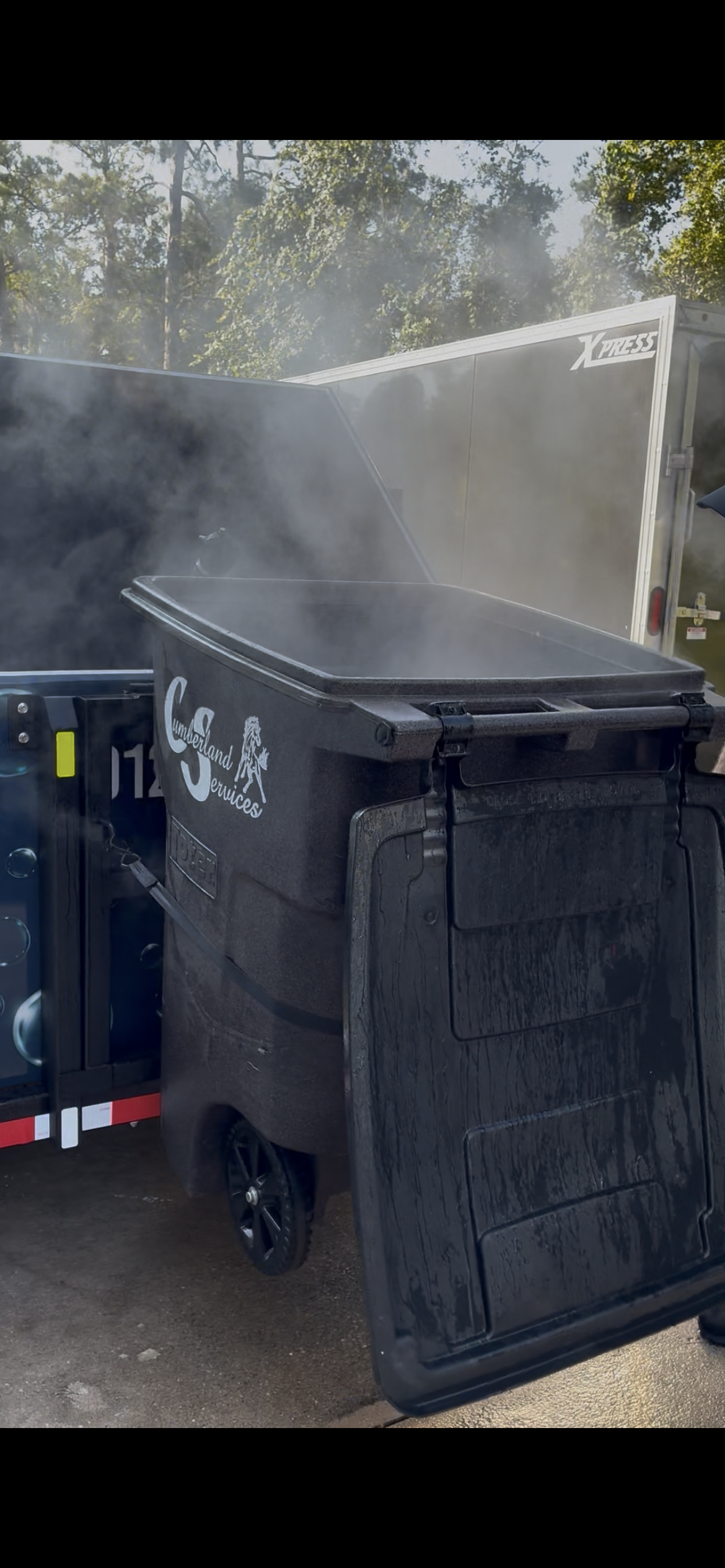 Harbor Bin Care trailer with steam rising from hot water cleaning