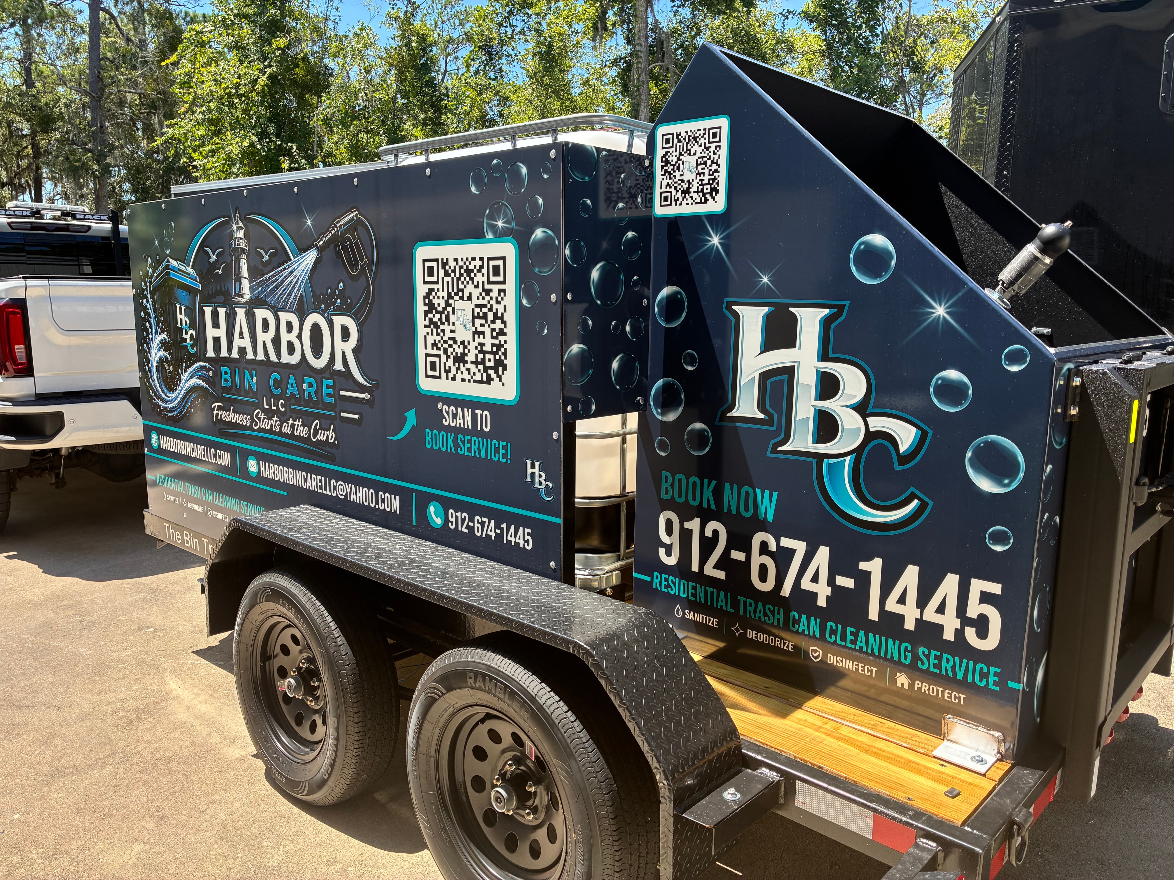Harbor Bin Care LLC fully wrapped trailer — side and rear view showing branding, QR code, and phone number